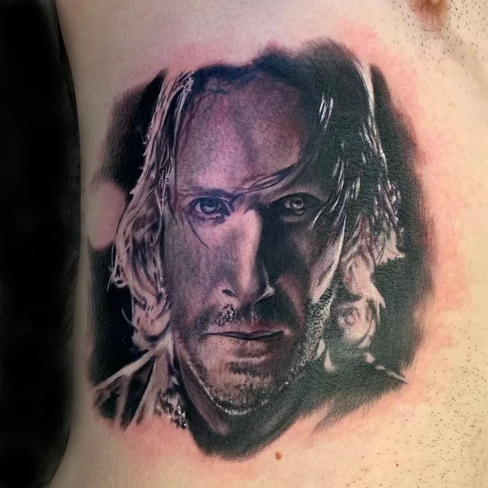 Realistic portrait chest tattoo done in fine line black and grey ink by tattoo artist Russ Howie of Sacred Mandala studio in Durham, NC.